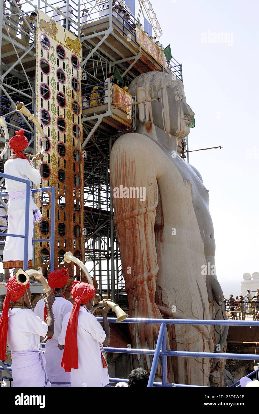 Les dévots jaïn versant de l'eau Vermillon sur la tête de la statue monolithique de 58,8 pieds de jaïn saint Gomateshwara (Seigneur Bahubali) dans Mahamastakabhisheka (h Banque D'Images