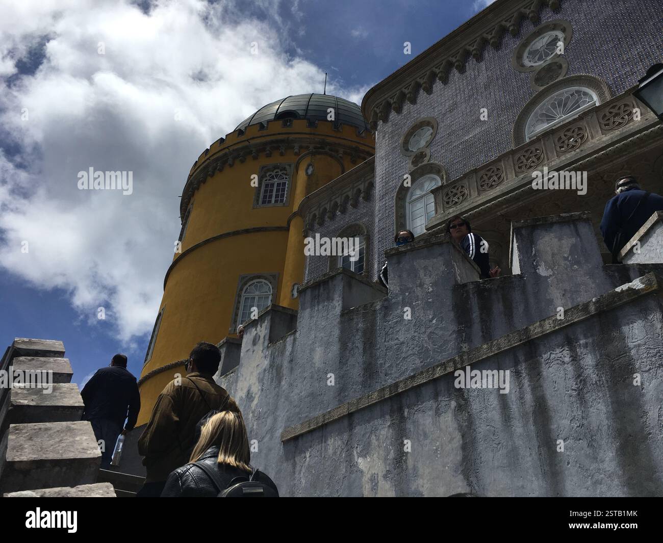 Une personne, perdue dans un livre, est assise à une table à Sintra, au Portugal. La personne porte un chapeau et des lunettes. Le livre peut être un roman ou un manuel. Est le PER Banque D'Images