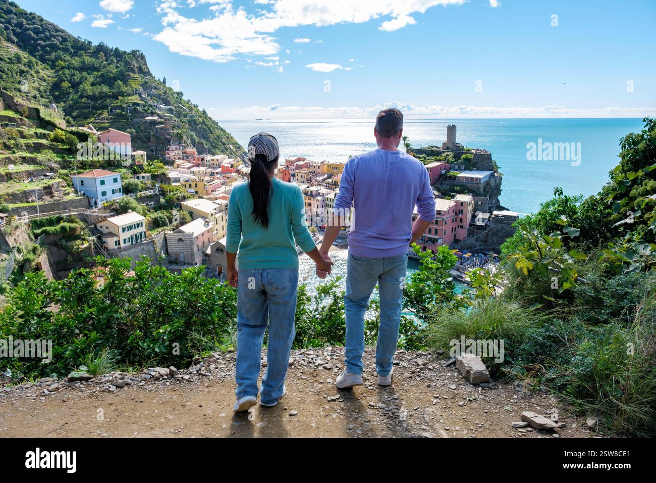 Couple profitant d'une vue imprenable sur Cinque Terre village coloré par un après-midi ensoleillé Banque D'Images