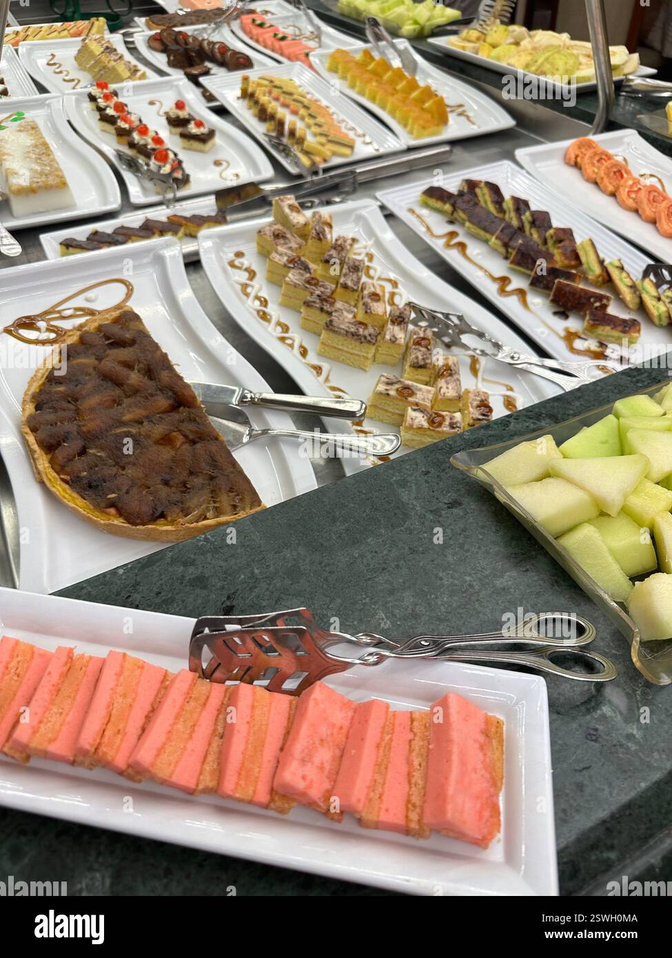 Variété de gâteaux comme dessert et melon exposés dans une croisière sur le Nil, Egypte Banque D'Images