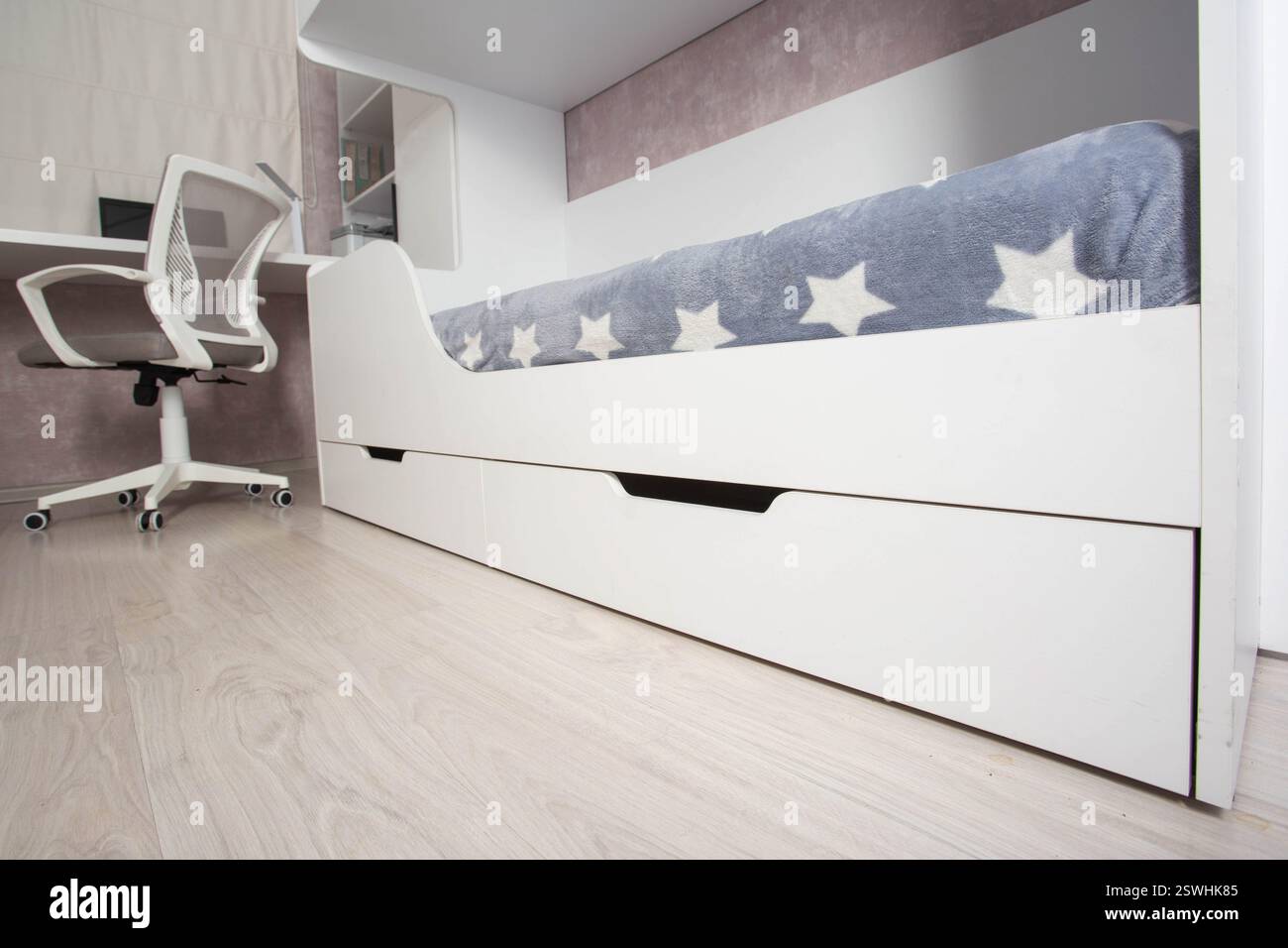Intérieur d'une chambre d'enfants moderne avec un lit superposé, une commode et une table avec un ordinateur portable et une chaise d'ordinateur. Intérieur de chambre blanc, bl Banque D'Images