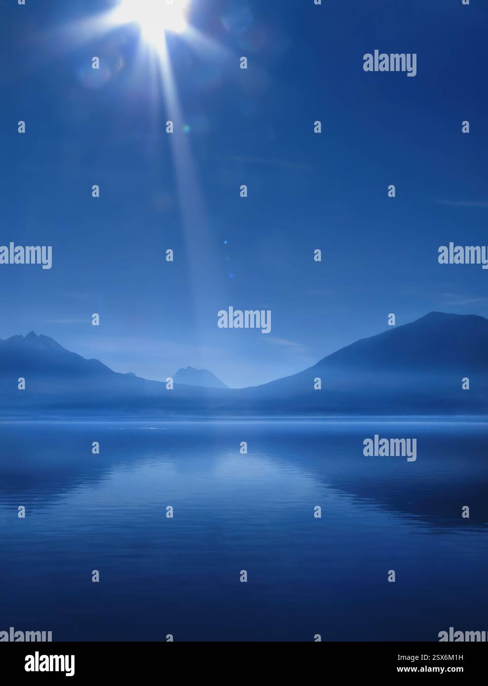 Photographie de paysage du lac Léman par une journée ensoleillée, reflets de l'objectif, les montagnes qui se reflètent dans le lac, bleu monochrome, espace copie, vertical Banque D'Images