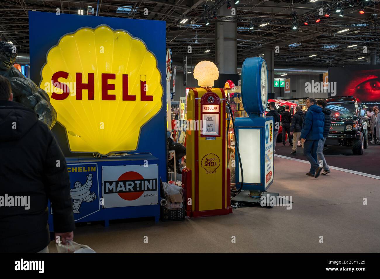 Exposition de stations-service rétro présentant des enseignes vintage et des pompes nostalgiques lors d'une foire automobile dans un centre de congrès moderne Banque D'Images