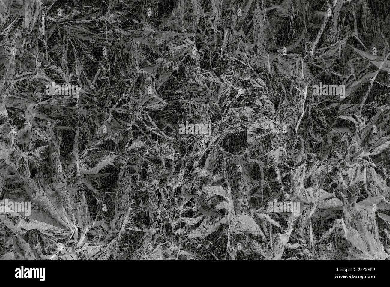 Motif texturé abstrait ressemblant à du papier froissé dans des tons monochromes Banque D'Images