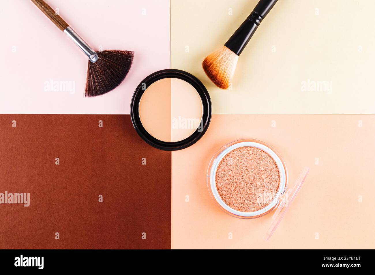 Une couche plate de maquillage essentiels, y compris la poudre et le fond de teint avec des pinceaux, mis sur un fond de couleur pastel. Parfait pour la beauté, la mode, un Banque D'Images