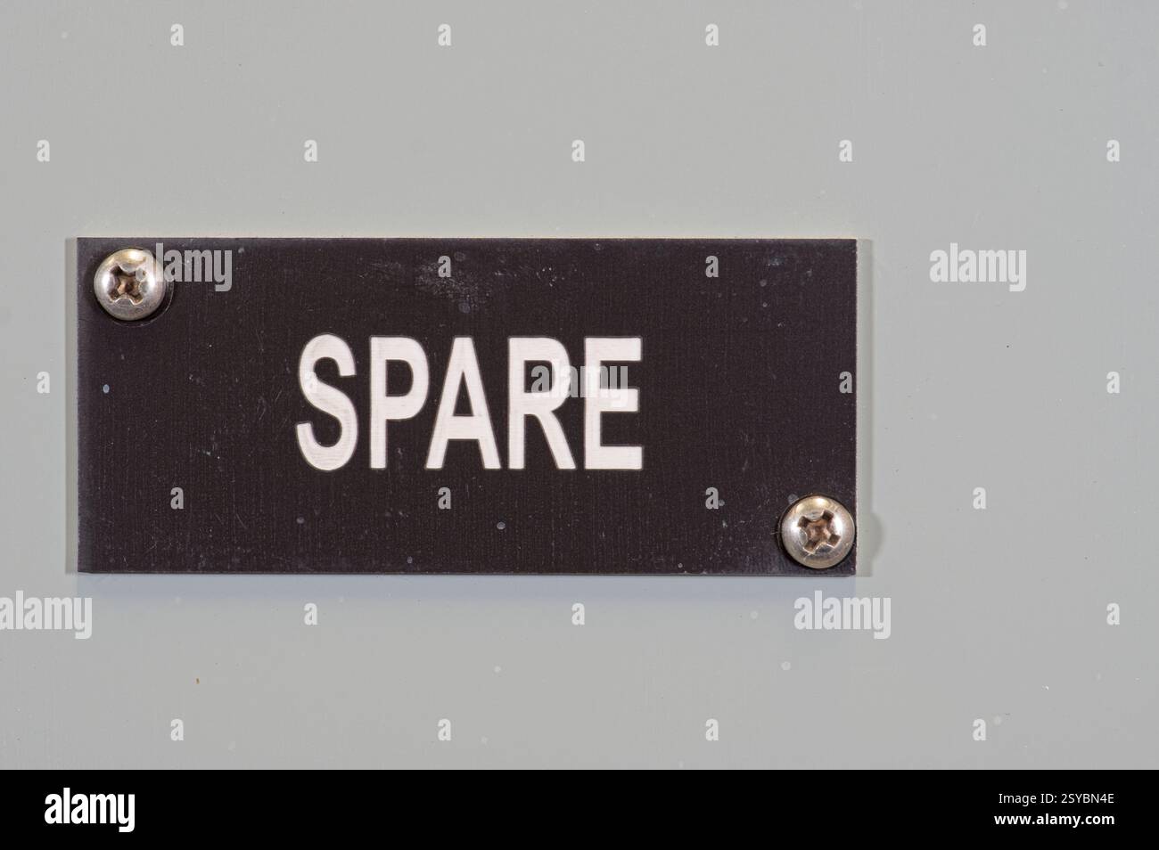 Étiquette en plastique gravée sur un panneau métallique portant la mention Spare Banque D'Images