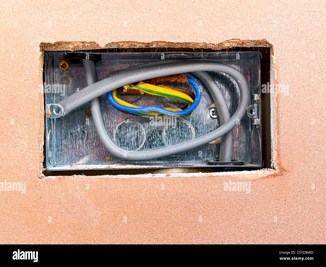 Prise électrique dans un trou coupé dans des plaques de plâtre sur les murs d'une extension de maison. Personne. Banque D'Images Prise électrique dans un trou coupé dans des plaques de plâtre sur les murs d'une extension de maison. Personne. Banque D'Images