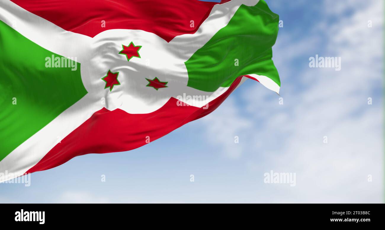 Drapeau national du Burundi brandissant par temps clair. Croix diagonale blanche se divisant en sections rouge et verte, trois étoiles vertes au centre. 3d illustr Banque D'Images