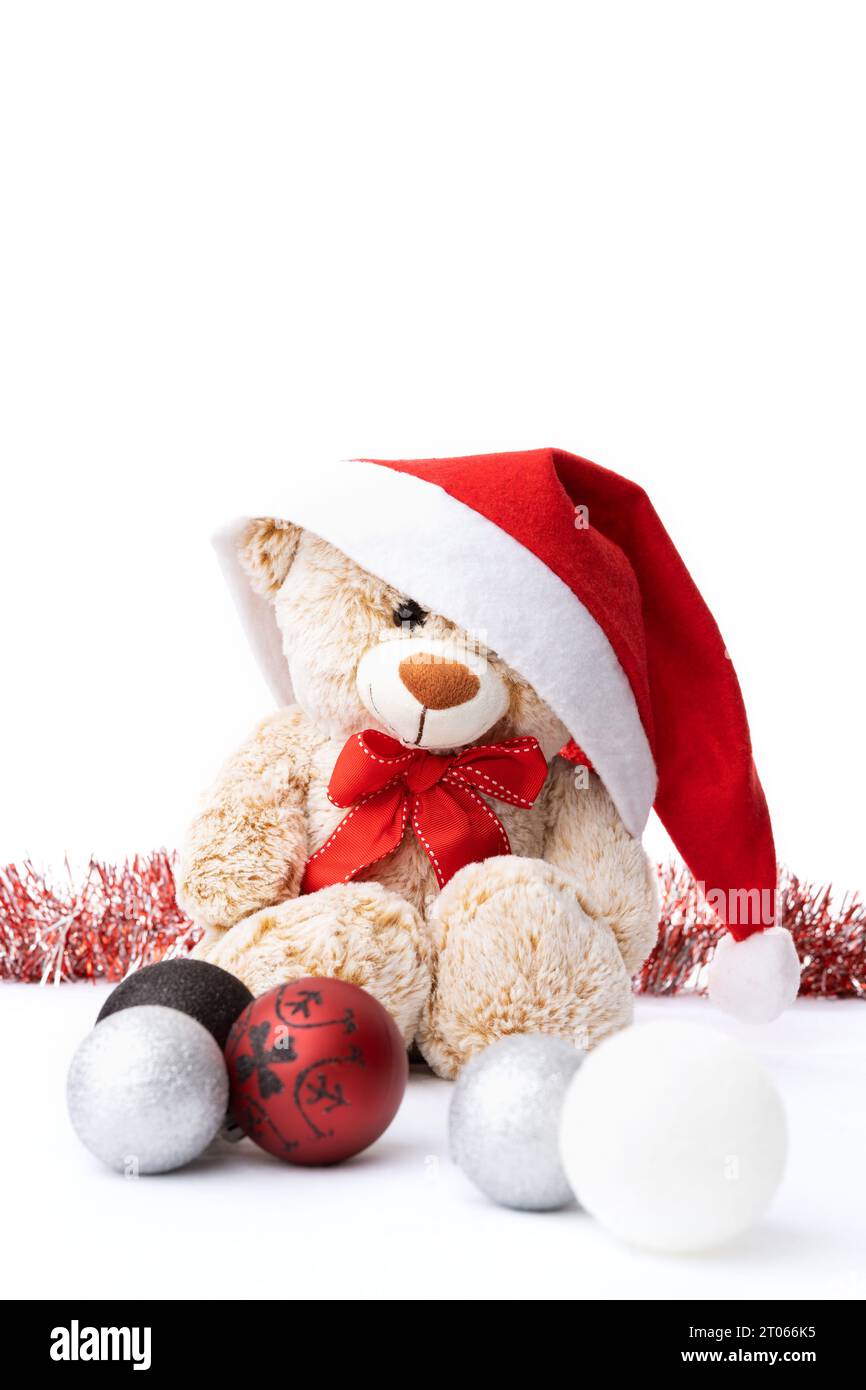 Ours en peluche portant un chapeau de Père Noël dans une scène de Noël Banque D'Images