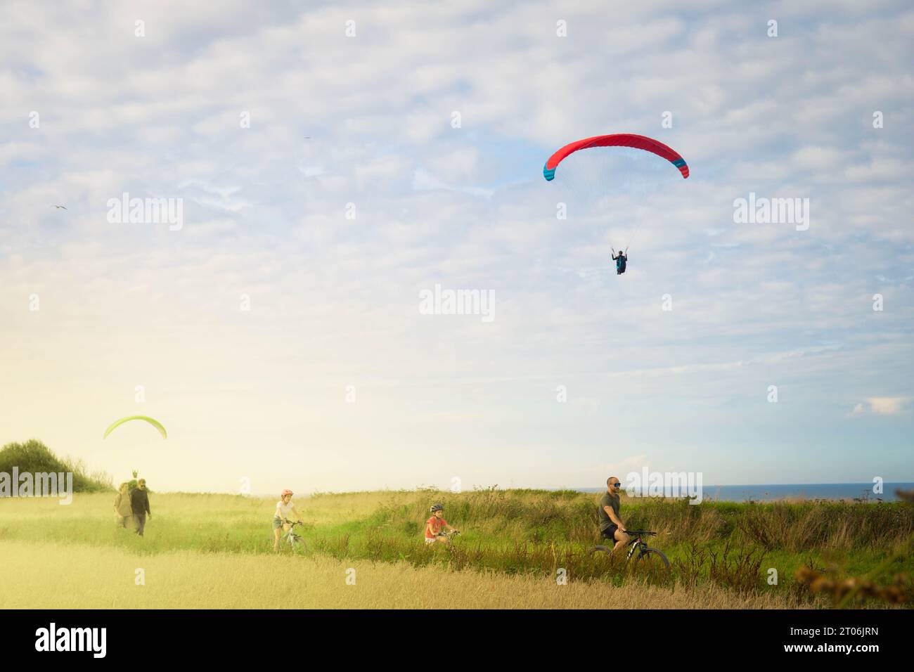 VIERVILLE SUR mer, août 2023 - le spot de parapente sur Omaha Beach, avec des gens sur les bycicles au coucher du soleil. Banque D'Images