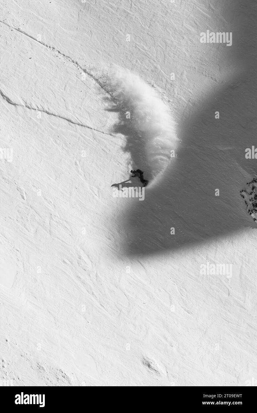 Snowboarder anonyme en costume de ski chaud et avec des snowboards faisant du sport dans les montagnes enneigées à Ushuaia Argentine Banque D'Images