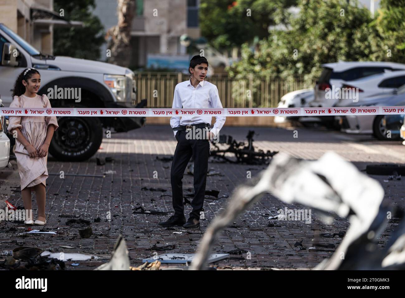 Ashkelon, Israël. 07 octobre 2023. Les résidents regardent les débris de véhicules détruits à la suite d’une attaque à la roquette depuis Gaza. Des militants palestiniens à Gaza ont tiré de manière inattendue des dizaines de roquettes sur des cibles israéliennes tôt samedi, a déclaré l’armée israélienne. Crédit : Ilia Yefimovich/dpa/Alamy Live News Banque D'Images