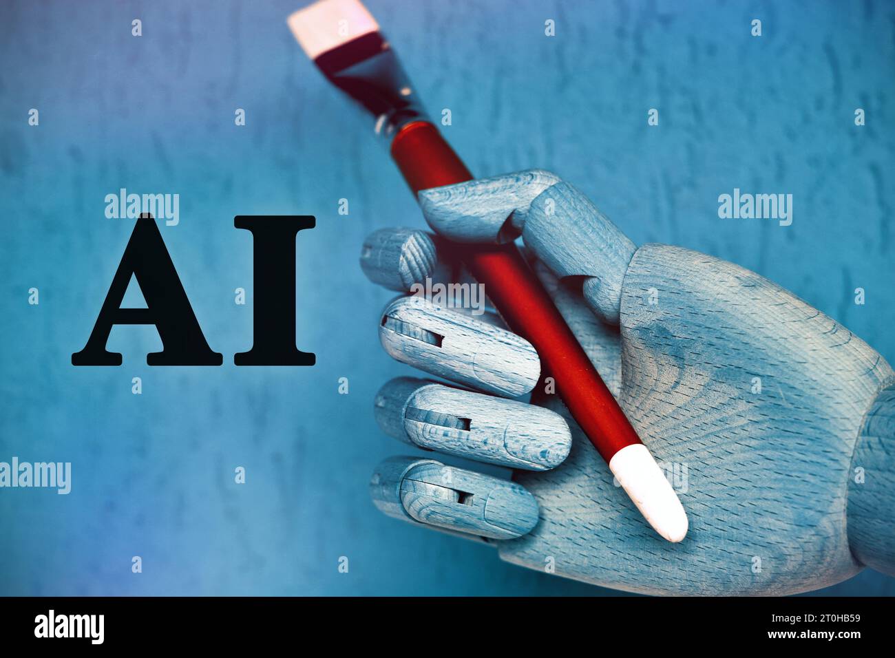 Main de robot tenant un pinceau. Banque D'Images