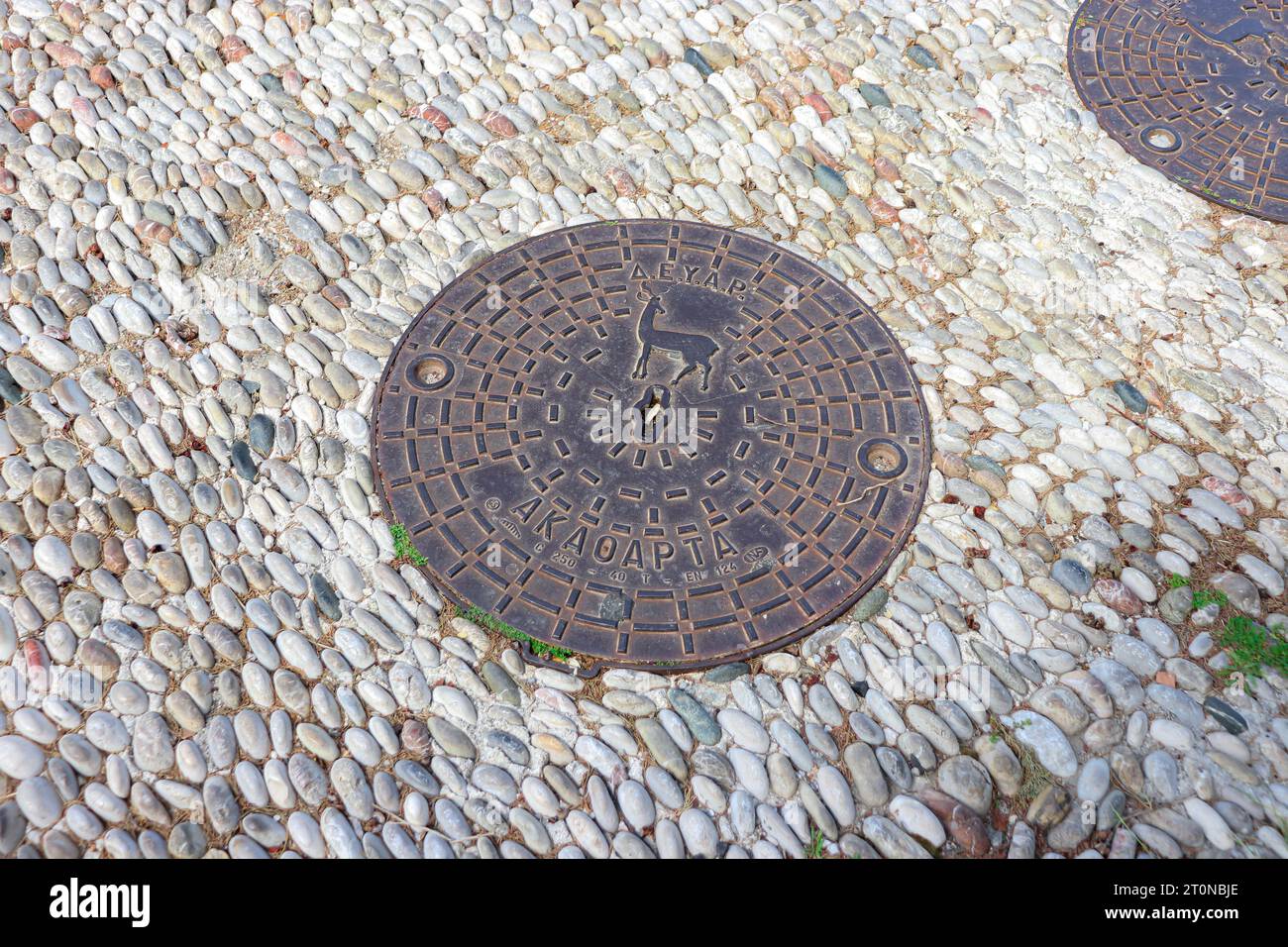 Couvercle rond de trou d'homme, une plaque amovible recouvrant une ouverture dans le sol conçue pour l'Acropole de Rhodes Banque D'Images