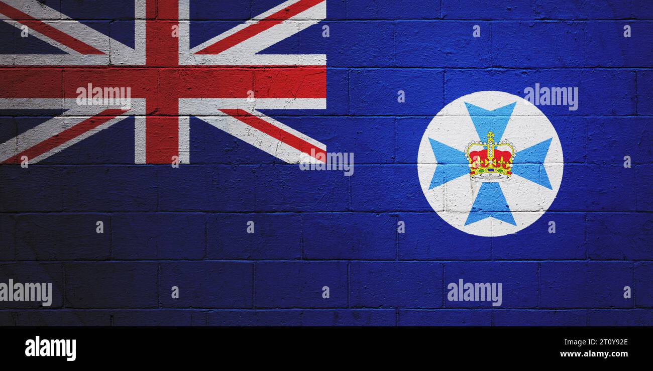 Drapeau du Queensland peint sur un mur en blocs de cendre. Banque D'Images