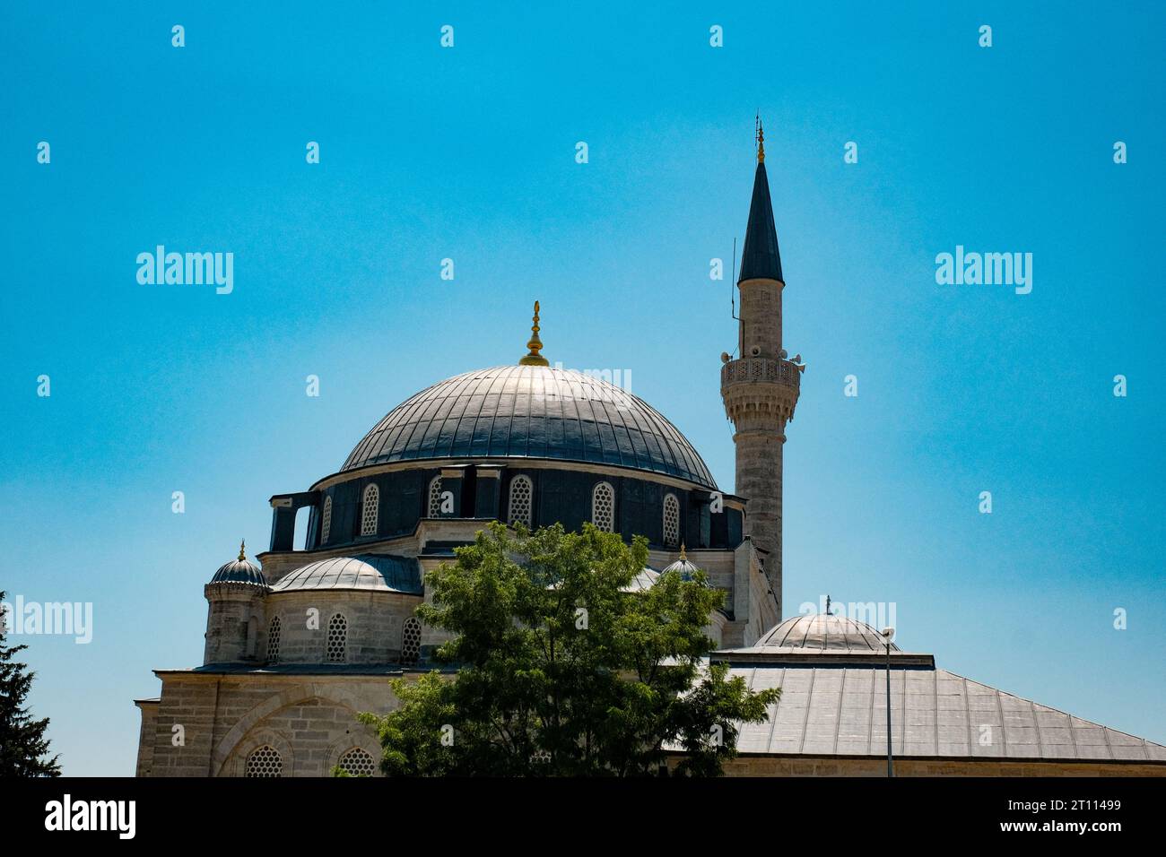 Une mosquée turque traditionnelle, avec sa silhouette élégante clairement définie contre le ciel, crée une scène captivante à fort contraste. Banque D'Images