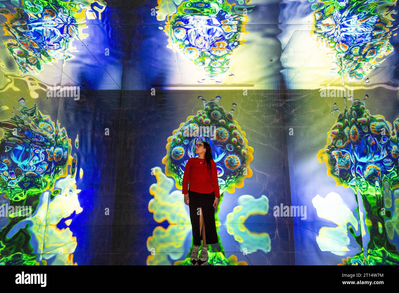 Londres, Royaume-Uni. 11 octobre 2023. Un membre du personnel de formations Space, qui fait partie de latent Spaces, une nouvelle exposition immersive présentée en avant-première à Illuvisionaries à Crossrail place, Canary Wharf. Le spectacle, de Markos Kay, artiste multidisciplinaire handicapé, qui utilise l’animation et l’intelligence artificielle pour brouiller les frontières entre réalité et illusion, ouvre au public le 14 octobre. Crédit : Stephen Chung / Alamy Live News Banque D'Images