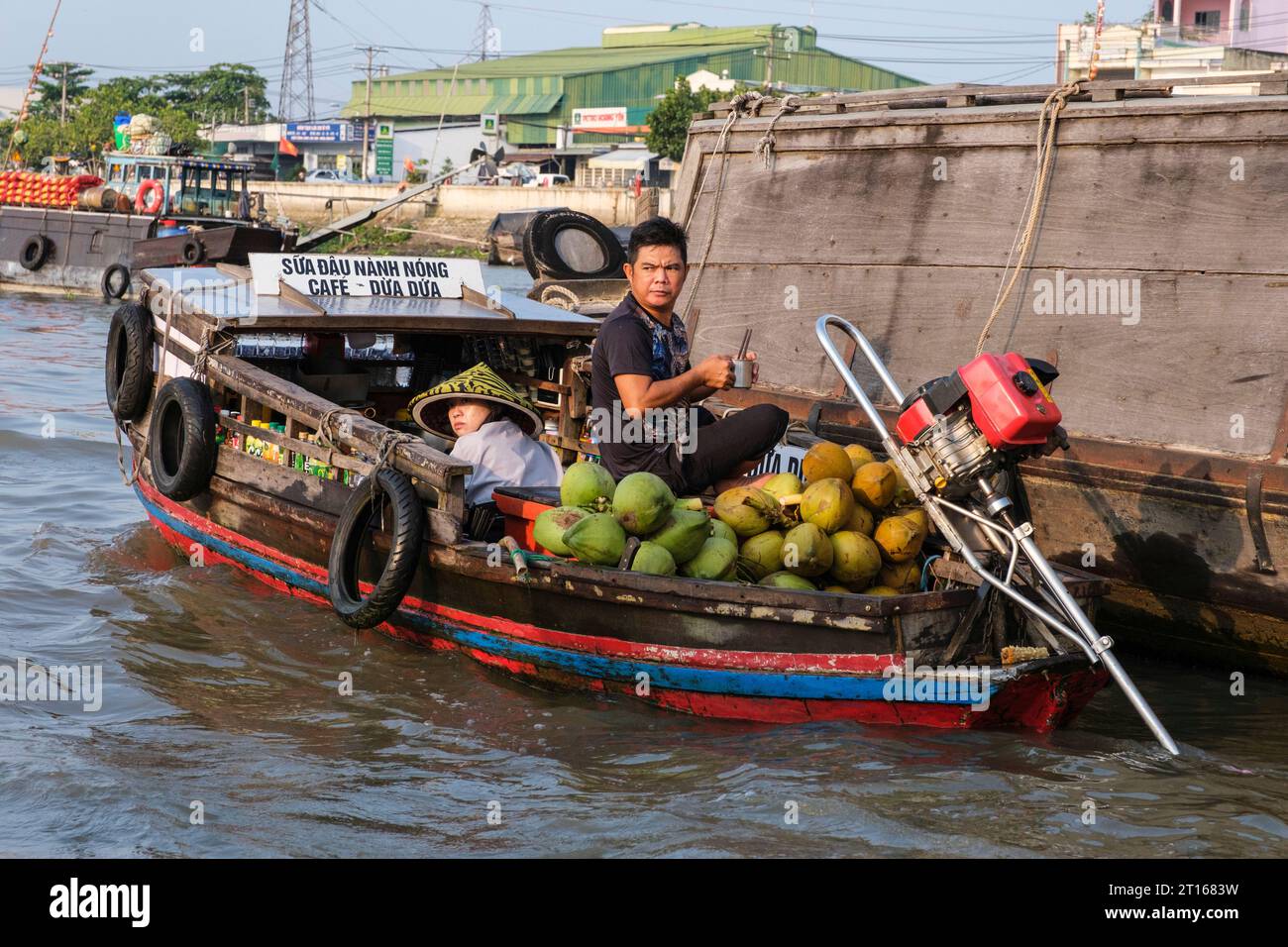 Scène du marché flottant de Fong Dien, près de CAN Tho, Vietnam. Le fournisseur d'articles pour le petit déjeuner circule parmi les grands bateaux transportant des fruits et légumes. Banque D'Images