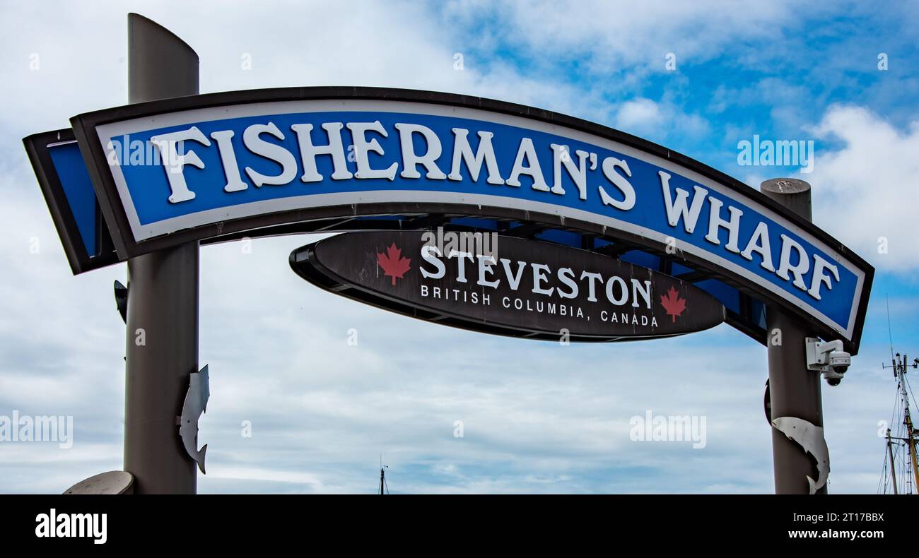 Un panneau bleu vibrant avec des lettres blanches à l'extérieur d'un restaurant de poissons annonçant « Fisherman's Wharf Banque D'Images