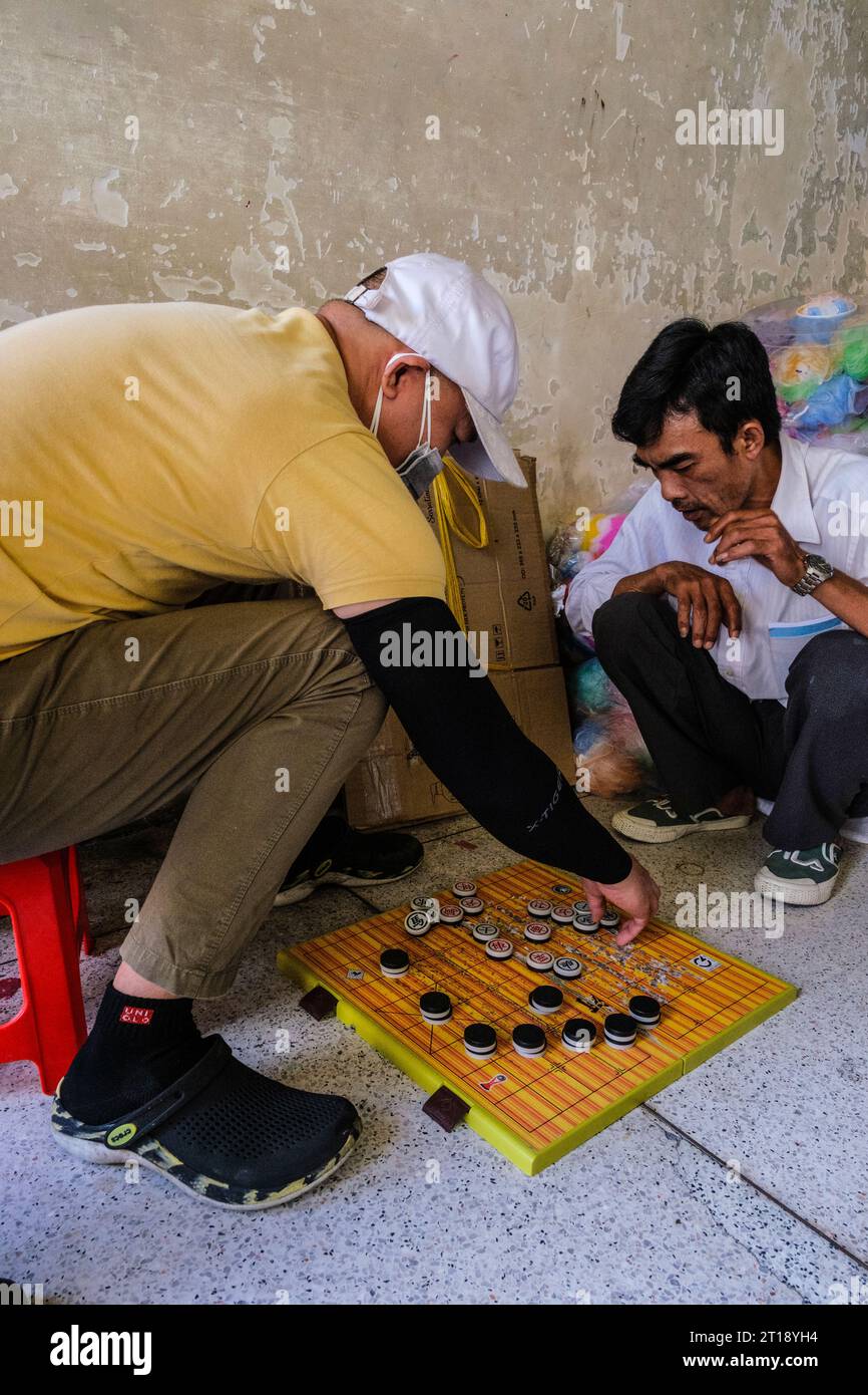 Hommes jouant aux échecs chinois, Co Vay, scène de marché Binh Tay, Ho Chi Minh ville, Vietnam. Banque D'Images