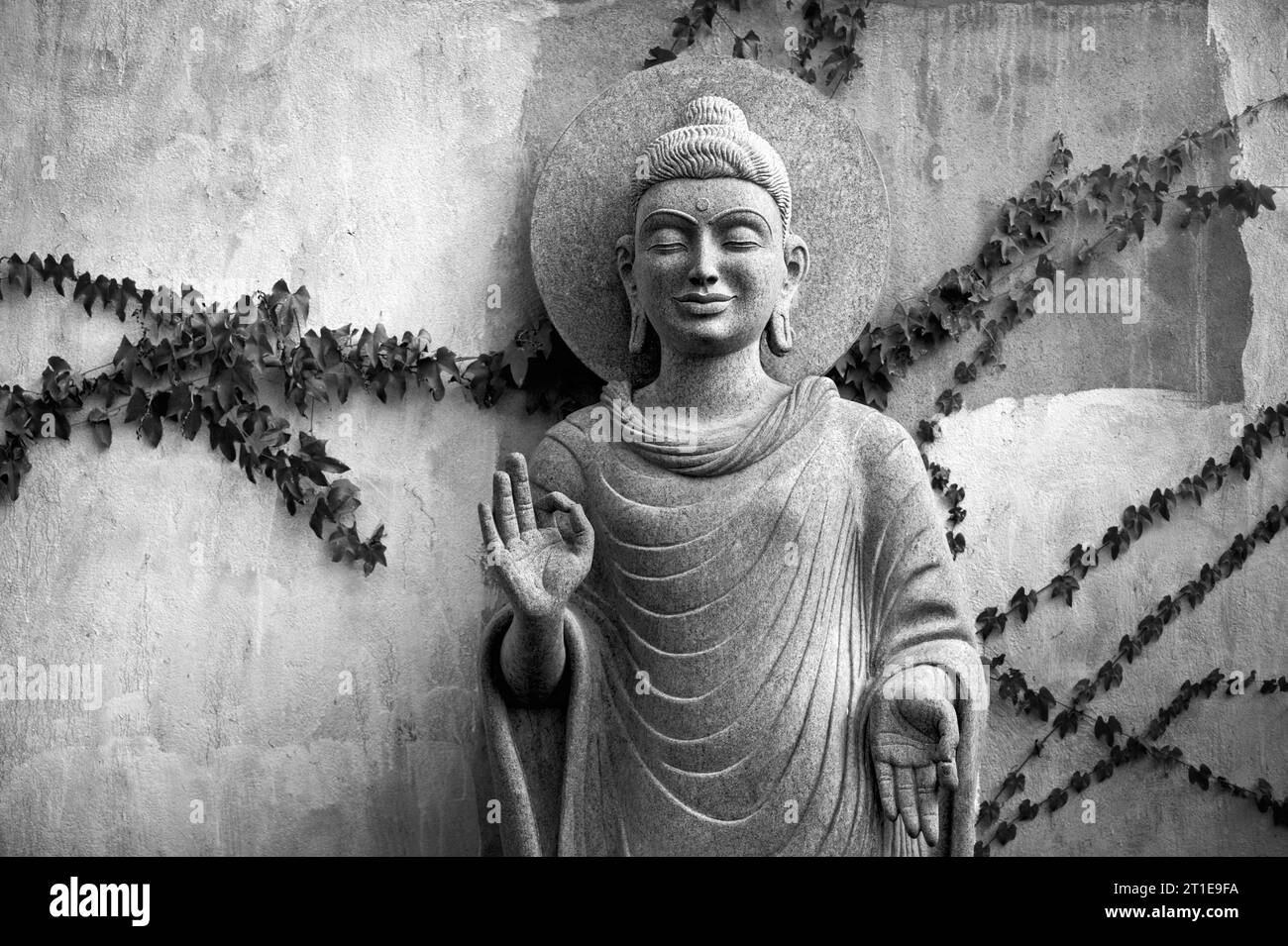 Sereinement belle statue de Bouddha sculptée dans la pierre de granit près des cinq Rathas à Mamallapuram, Tamil Nadu, Inde. Banque D'Images
