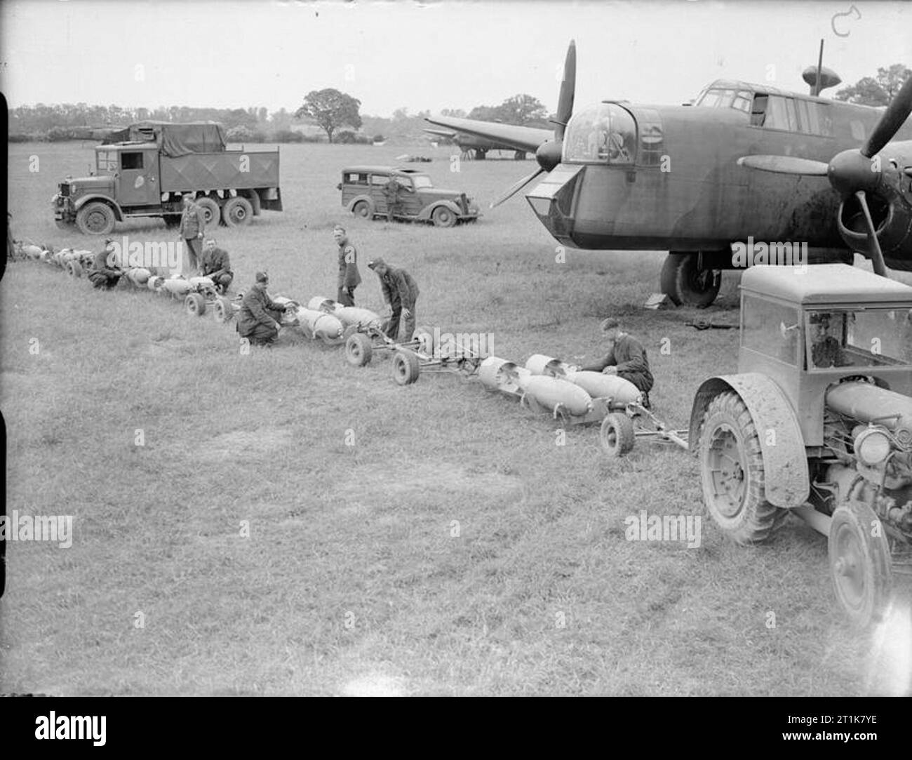 Royal Air Force Bomber Command, 1939-1941. Les armuriers préparer 500-lb GP des bombes sur des chariots tirés par des tracteurs, pour le chargement dans un Armstrong Whitworth Whitley Mark V du No 58 Squadron RAF à Linton-on-Ouse, dans le Yorkshire. Banque D'Images