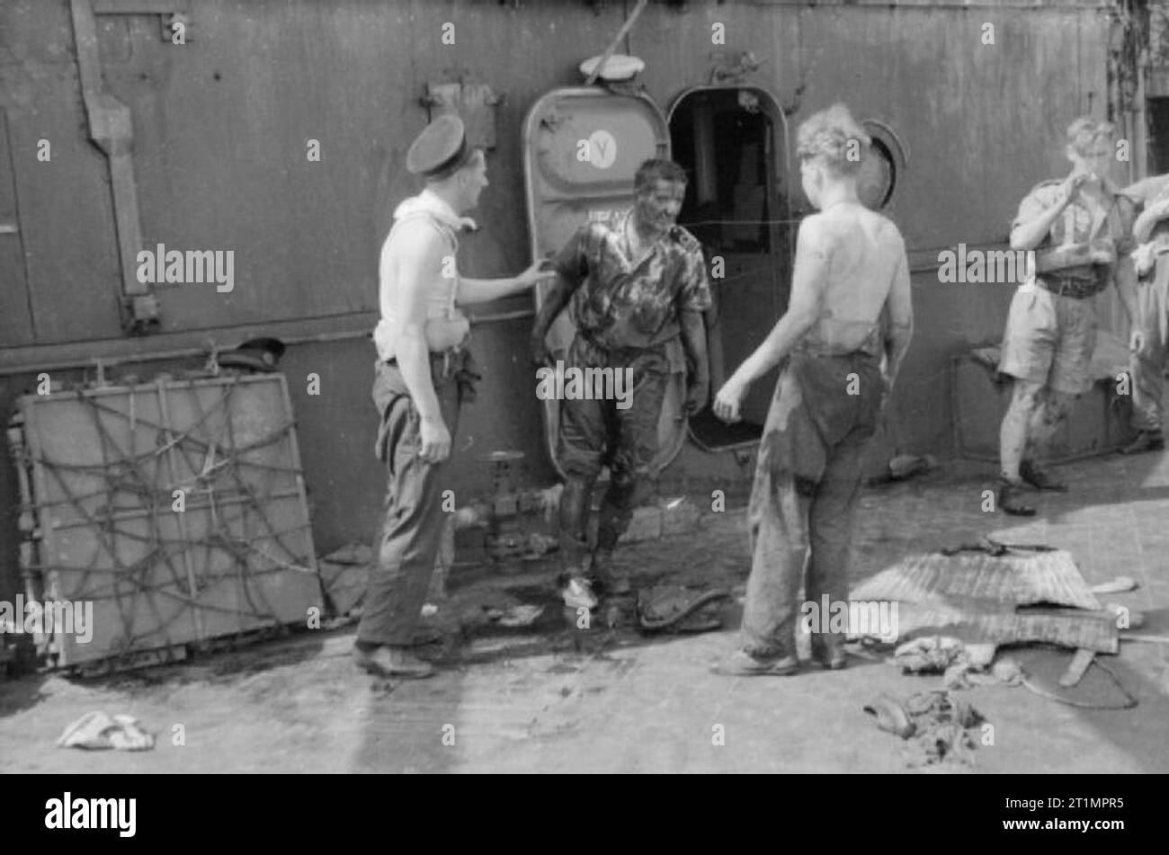 La Royal Navy pendant la Seconde Guerre mondiale, un agent d'une équipe de sauvetage à bord du HMS MANCHESTER remonte de sous le pont couvert dans l'huile combustible. Tout en prenant part à des convois à Malte en Méditerranée, le croiseur avait été frappé par une torpille aérienne et l'équipe de sauvetage a été mise en place d'équipage coincés sous le pont. Banque D'Images