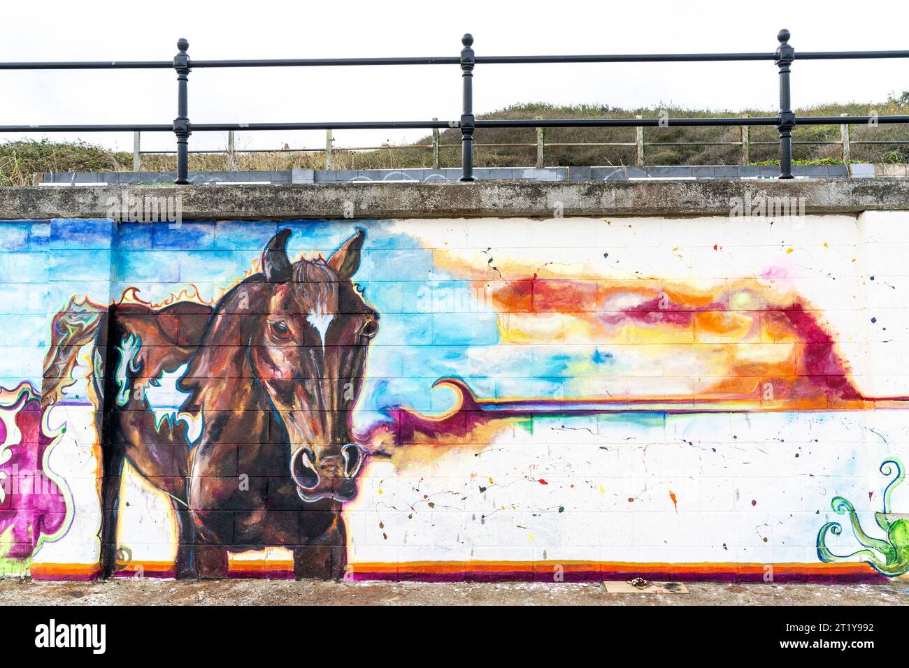 Graffiti en bord de mer sur une digue à Herne Bay sous la forme d'une peinture très détaillée d'un cheval avec des trous transparents, face au spectateur. Peint par une jeune femme inconnue, le tableau fait partie d'une série liée par un horizon commun le long du mur. Banque D'Images
