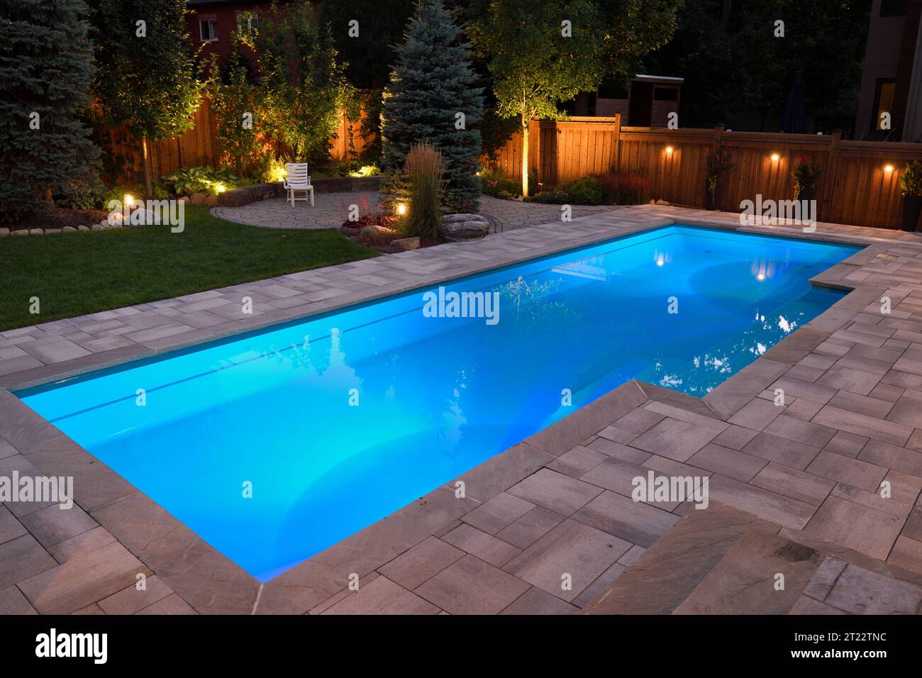 Lumières dans la piscine et jardin patio et terrasse la nuit Banque D'Images
