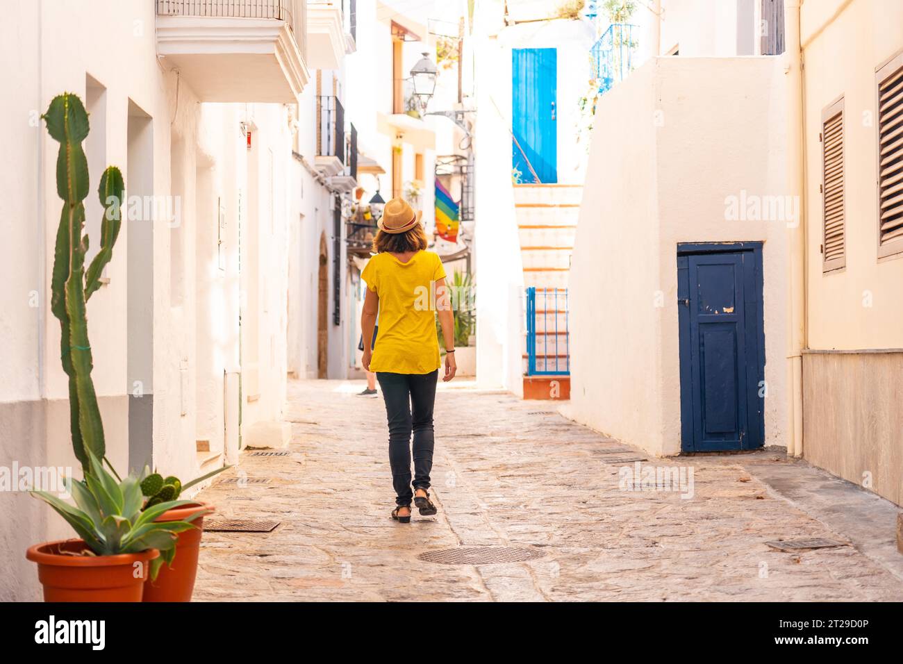 Une jeune femme avec un chapeau visitant la vieille ville d'Ibiza, îles Baléares, Eivissa Banque D'Images