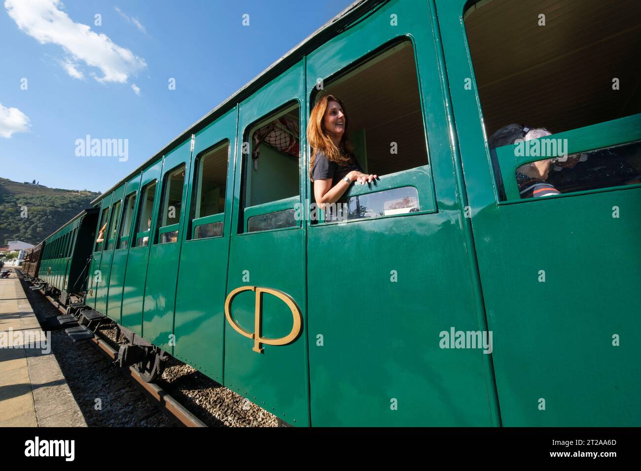Passager regardant par la fenêtre du train historique du Douro circulant entre Régua et Tua en suivant le fleuve Douro, Portugal, Europe Banque D'Images