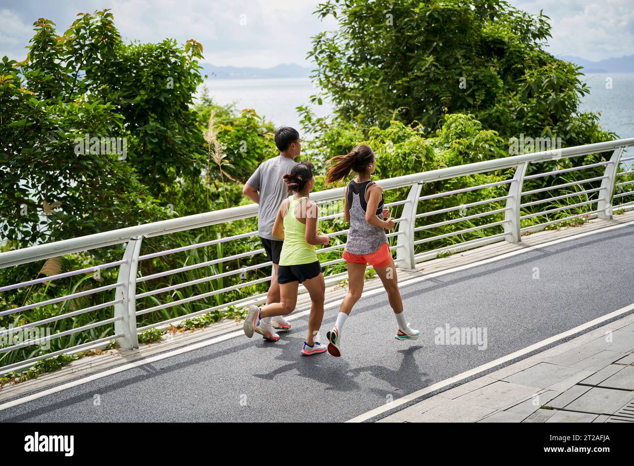 groupe de trois jeunes adultes asiatiques homme et femme courir jogging à l'extérieur dans le parc Banque D'Images