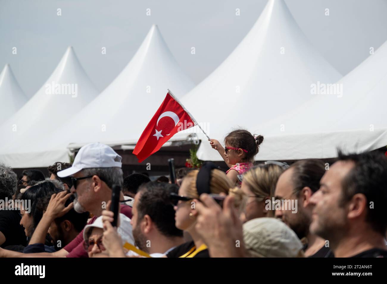 Izmir, Turquie, le 9 septembre 2023 : un moment réconfortant capturant une fillette de 8 à 9 ans avec des lunettes de soleil, perchée sur les épaules de son père, agitant le Banque D'Images