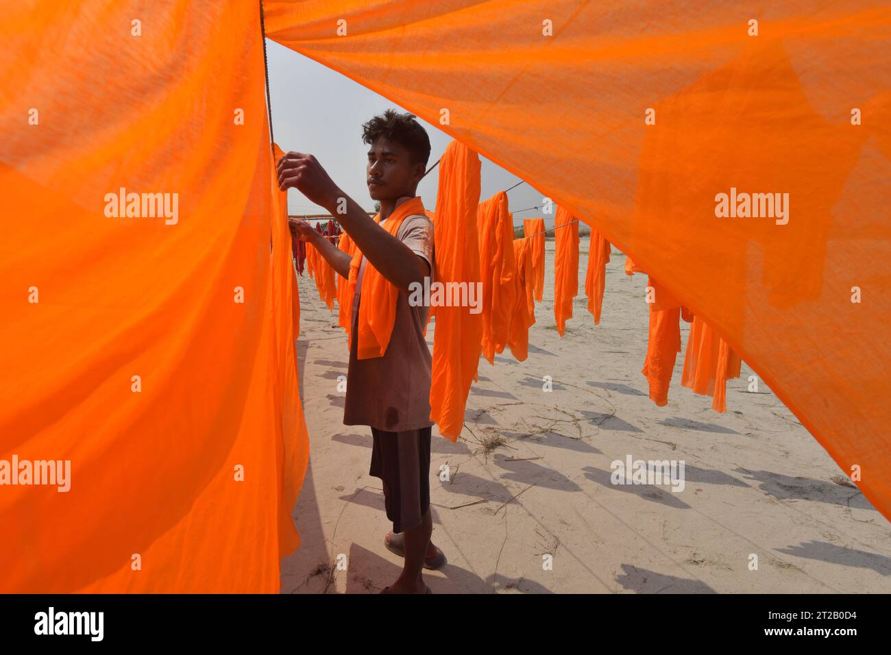 Narayanganj. 18 octobre 2023. Un ouvrier sèche un tissu coloré dans une usine de Narayanganj, Bangladesh, le 17 octobre 2023. Crédit : Xinhua/Alamy Live News Banque D'Images