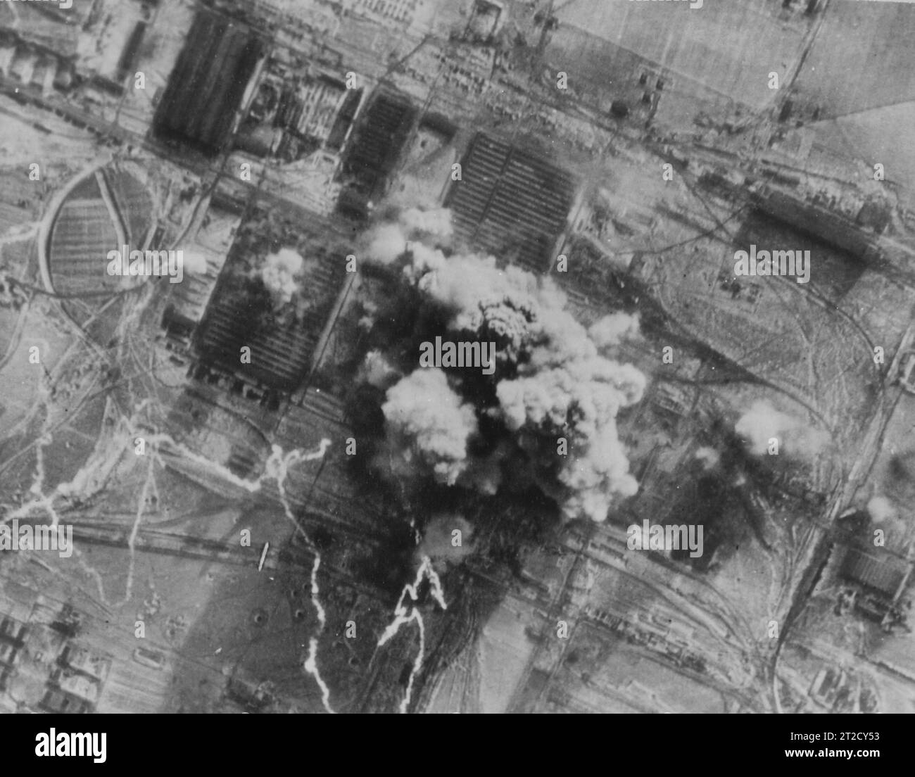 Un énorme champignon de fumée épaisse obscurcit complètement deux des principaux bâtiments de l'usine d'ingénierie Hermann Goering à Hallendorf, au sud de Brunswick, en Allemagne, alors que Consolidated B-24 Liberators larguaient leurs premières bombes sur les travaux le 14 janvier 45. Banque D'Images