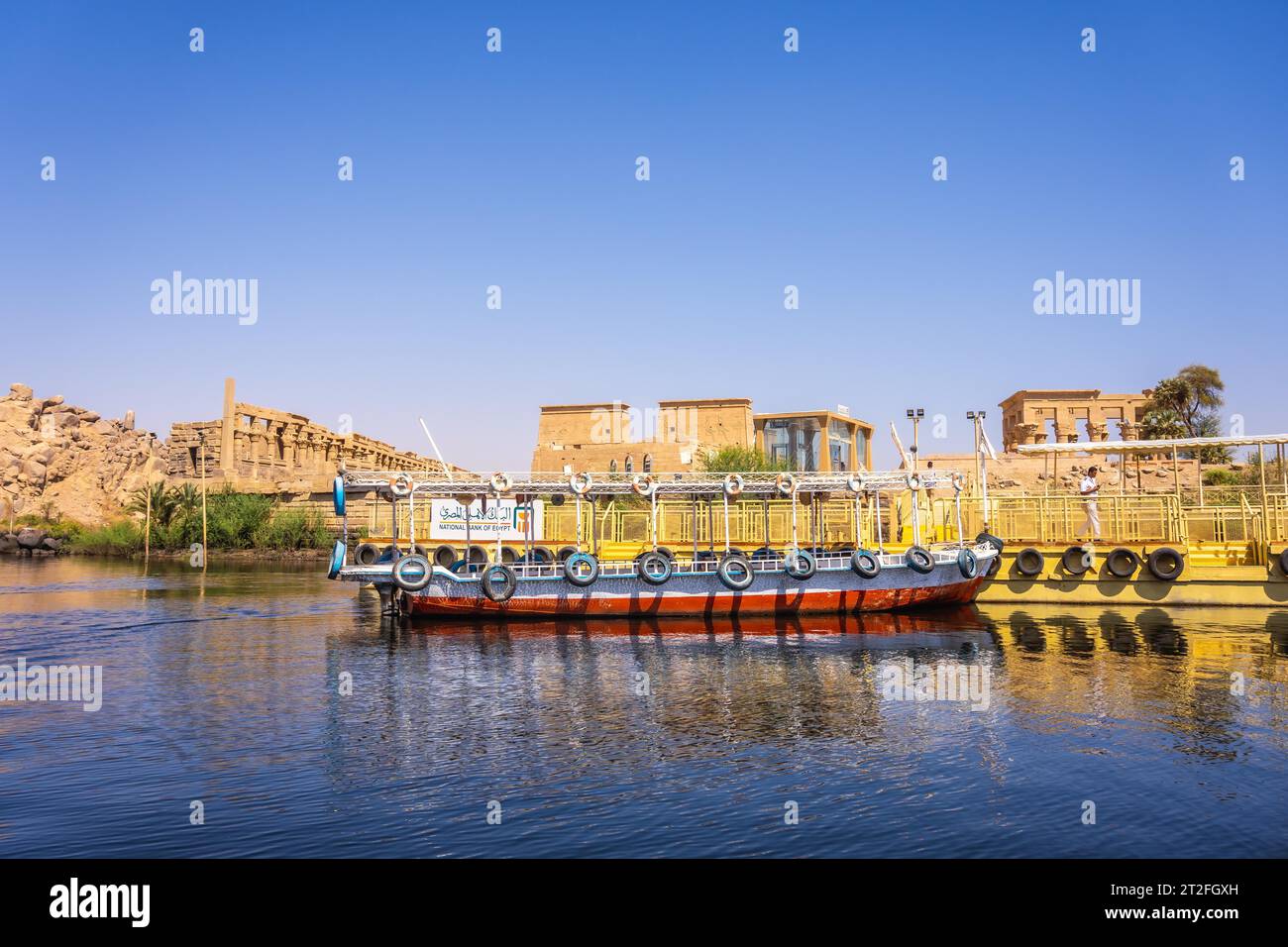 Bateaux de transport traditionnels vers le temple de Philae, une construction gréco-romaine vue du Nil, un temple dédié à Isis, déesse de Banque D'Images Bateaux de transport traditionnels vers le temple de Philae, une construction gréco-romaine vue du Nil, un temple dédié à Isis, déesse de Banque D'Images