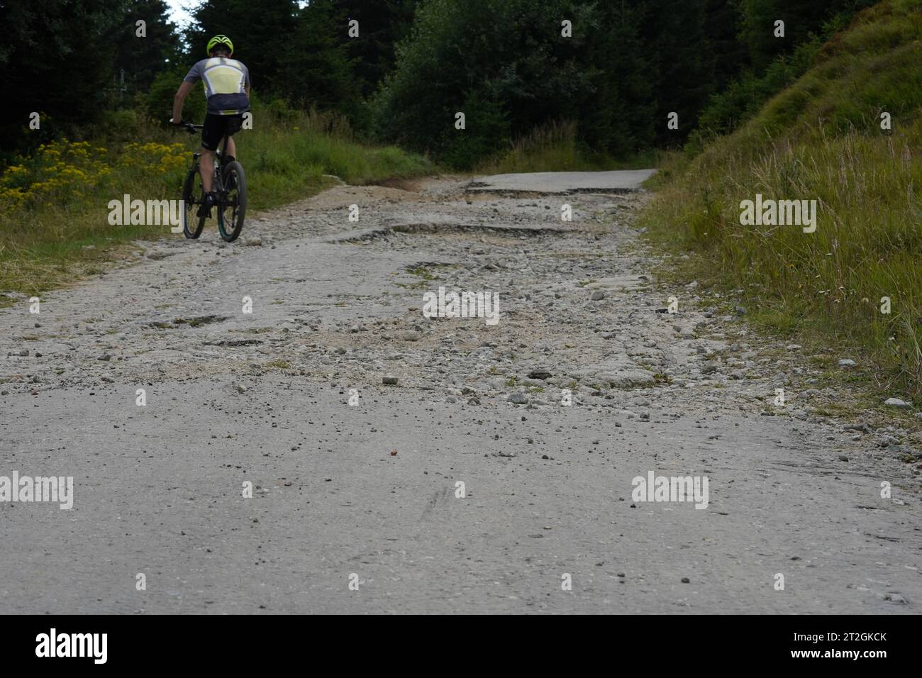 Homme faisant du vélo de montagne sur une route terrestre. Banque D'Images