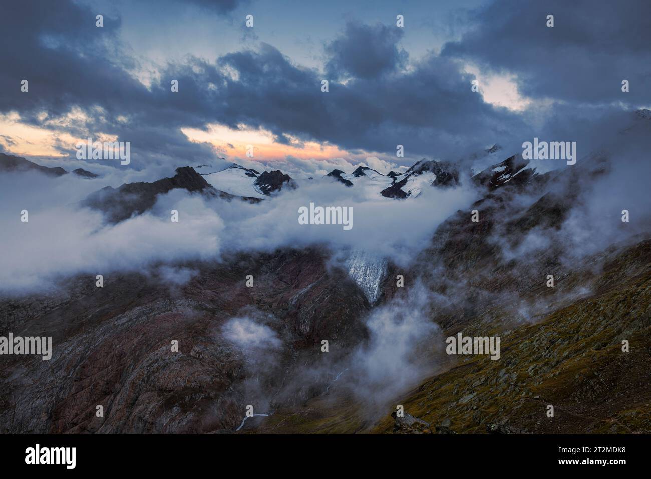 Vue depuis la cabane de montagne Ramolhaus de la crête alpine principale couverte de nuages et le Gurgler Ferner au crépuscule de la soirée, vallée de Gurgl, Alpes d'Oetztal Banque D'Images