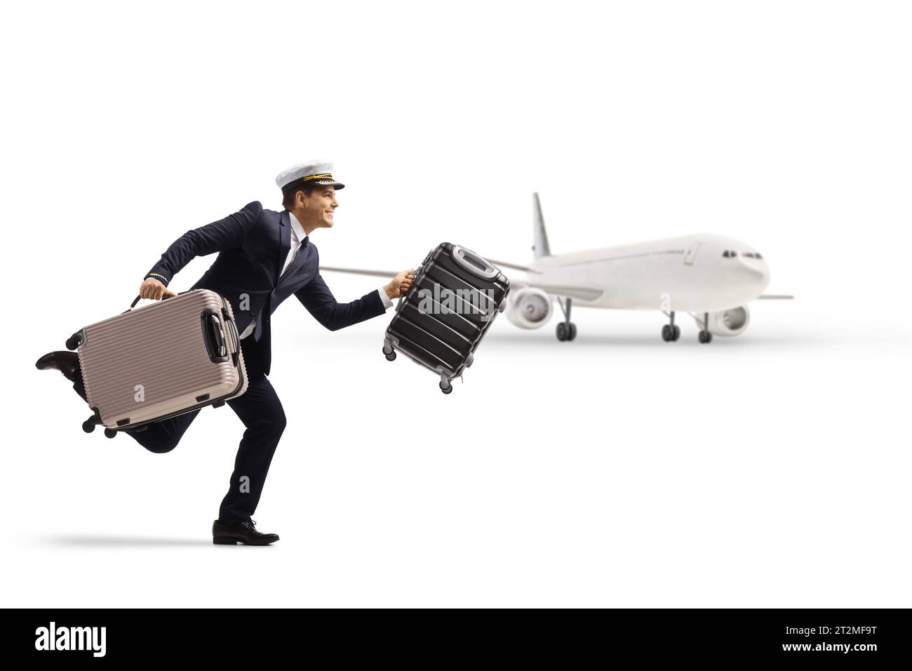 Plan de profil complet d'un pilote courant avec des valises devant un avion isolé sur fond blanc Banque D'Images