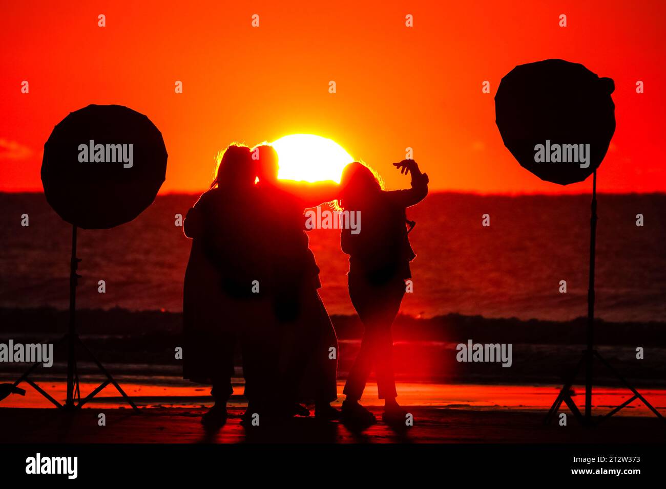 Île de Palms, États-Unis. 21 octobre 2023. Un photographe tient une séance photo découpée par le lever du soleil alors que le soleil se lève sur l'horizon de l'océan Atlantique depuis Front Beach, le 21 octobre 2023 à Isle of Palms, Caroline du Sud. Crédit : Richard Ellis/Richard Ellis/Alamy Live News Banque D'Images