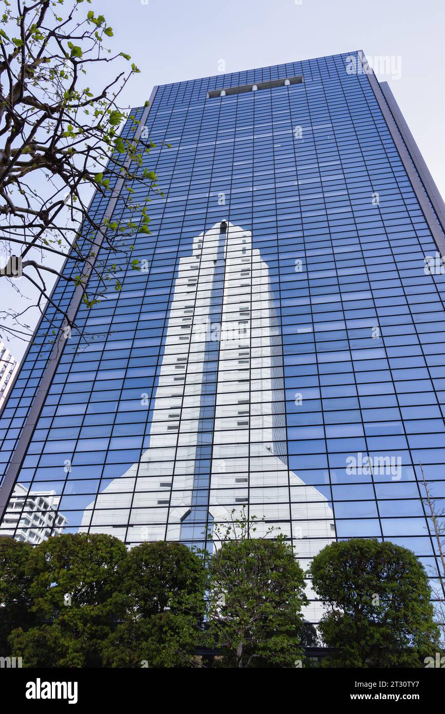 Tokyo, Japon - 09 avril 2023 : reflet de la Super Tower NEC dans la façade vitrée d'un autre gratte-ciel à Tokyo. C'est le siège de NEC Cor Banque D'Images