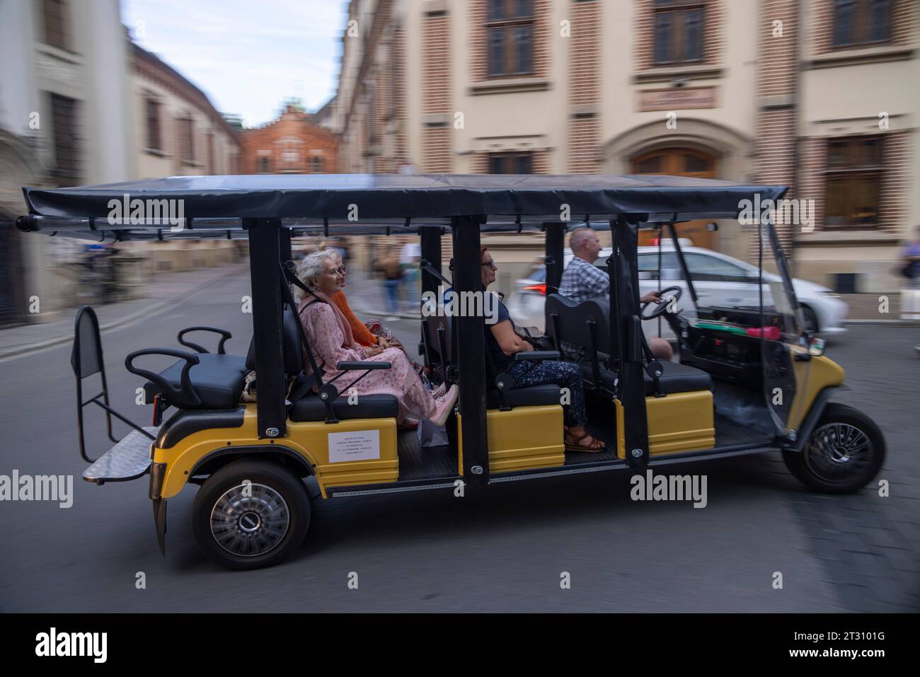 Touristes en voiturette électrique en tournée, vieille ville, Cracovie, Pologne Banque D'Images