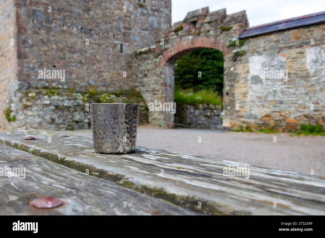 Castleward, County Down, Irlande du Nord, juillet 19 2023 - récipient à boire à fossettes métalliques assis sur une table en bois avec profondeur de champ Banque D'Images