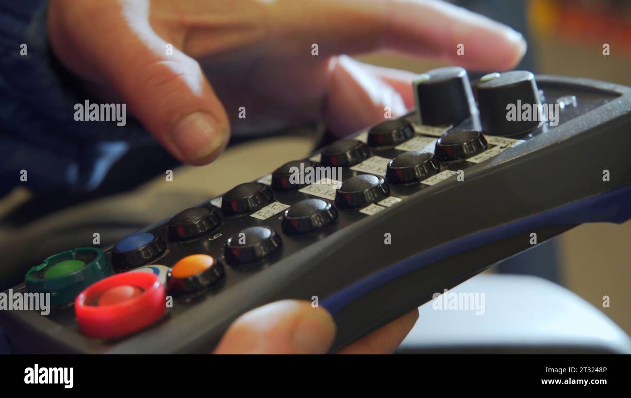 Panneau de commande noir. Créatif. Un panneau de commande spécial dans des mains masculines fortes. Banque D'Images