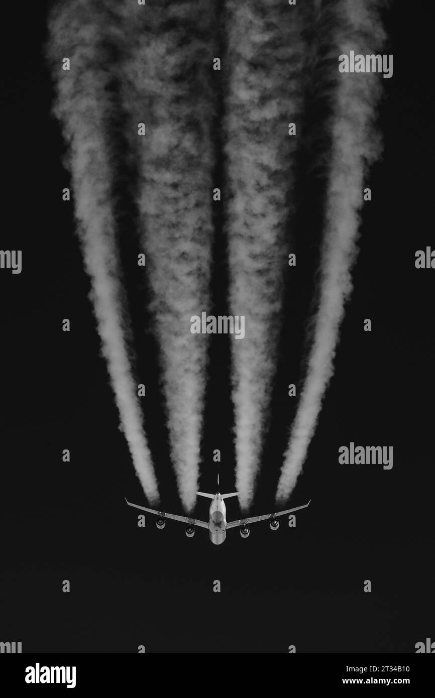 Jumbo Jet Mid Air d'en bas avec des contrails Banque D'Images