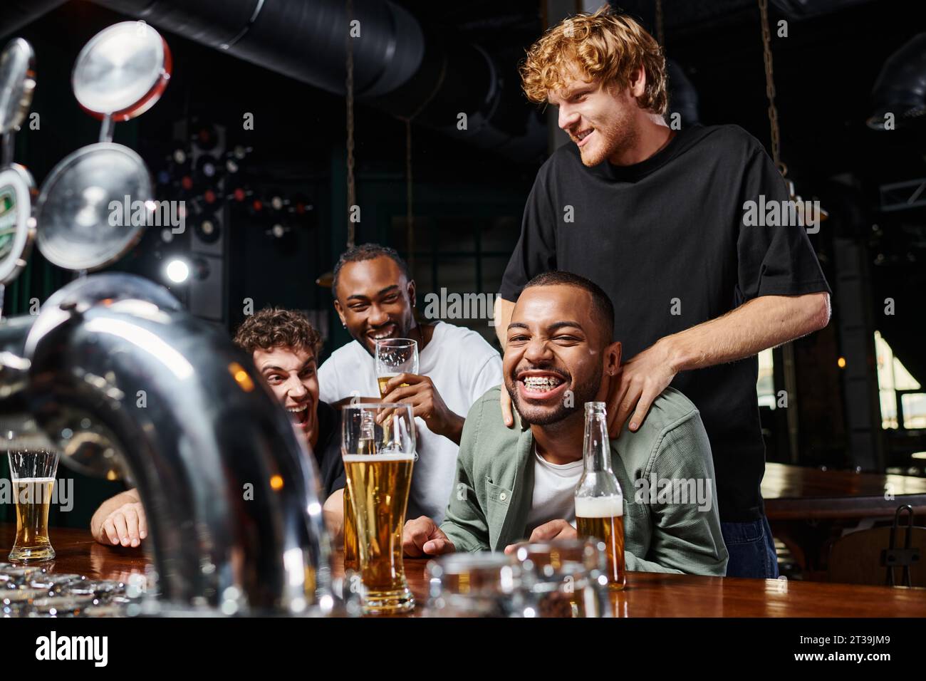 homme touchant les épaules du marié afro-américain heureux pendant la fête de célibataire, amitié masculine Banque D'Images