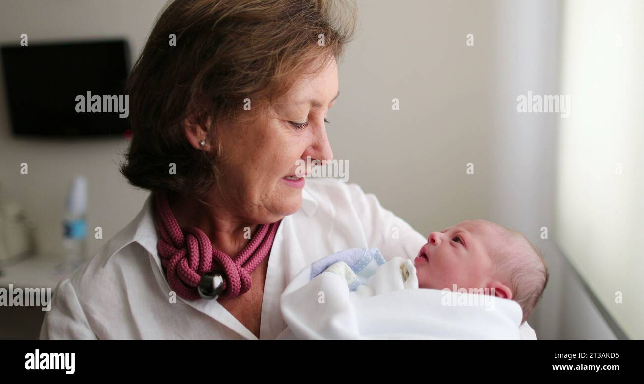 Nouveau-né bébé étant tenu par grand-mère, la vie réelle et authentique Banque D'Images