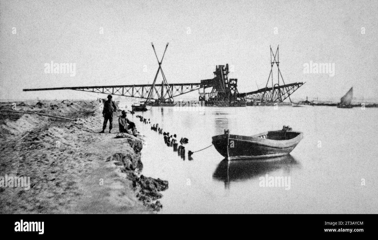 Photographie de deux ouvriers posant devant la drague du déversoir lors de la construction du canal de suez. Banque D'Images