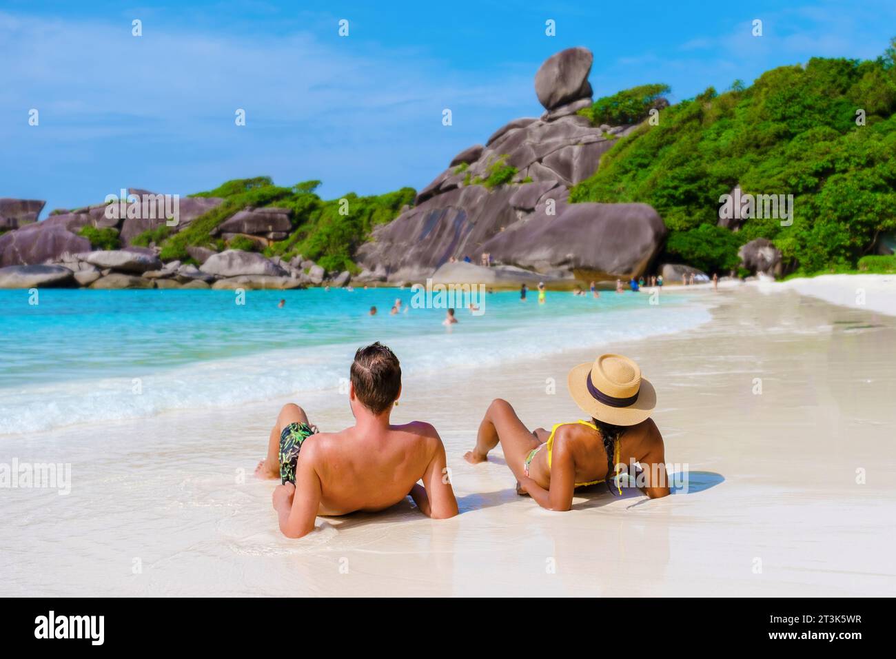 Femmes noires et hommes blancs se détendant sur la plage au soleil aux îles Similan en Thaïlande Phannga, un couple multiracial diversifié en vacances en Thaïlande Banque D'Images