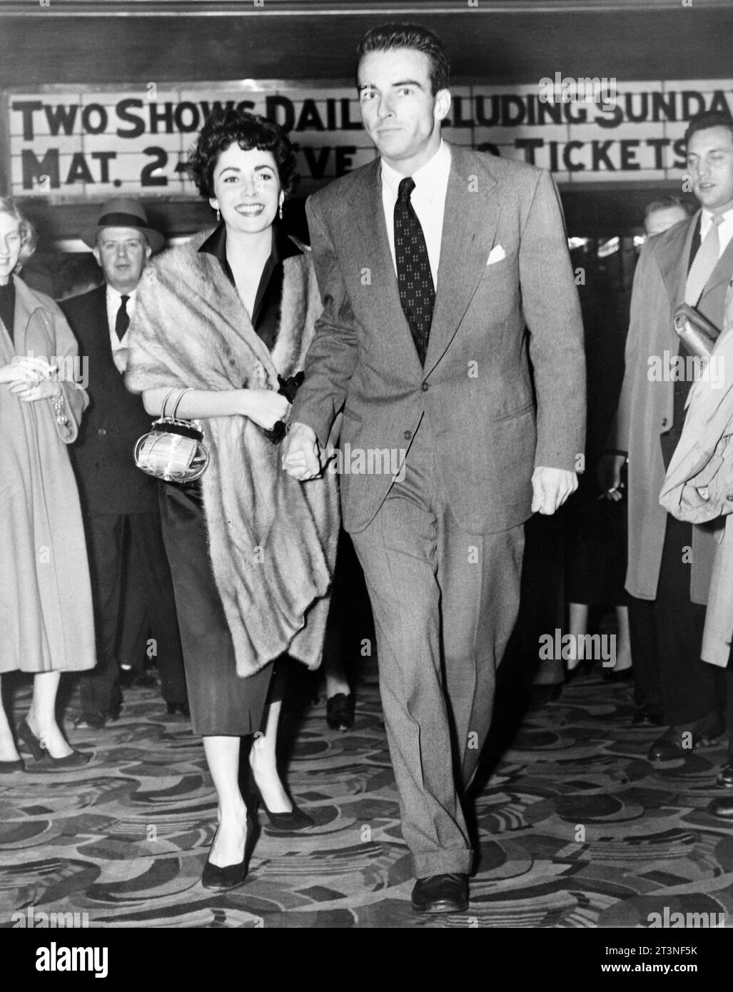 Liz Taylor & Montgomery Clift, New York City, 1951 Montgomery Clift et Elizabeth Taylor, portrait en pied, debout, face à l'avant, entrant au Palace Theatre à New York. Photographie de la presse associée, 1951. Banque D'Images